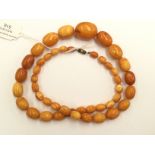 A string of graduated amber coloured beads, total gross weight approx 55.