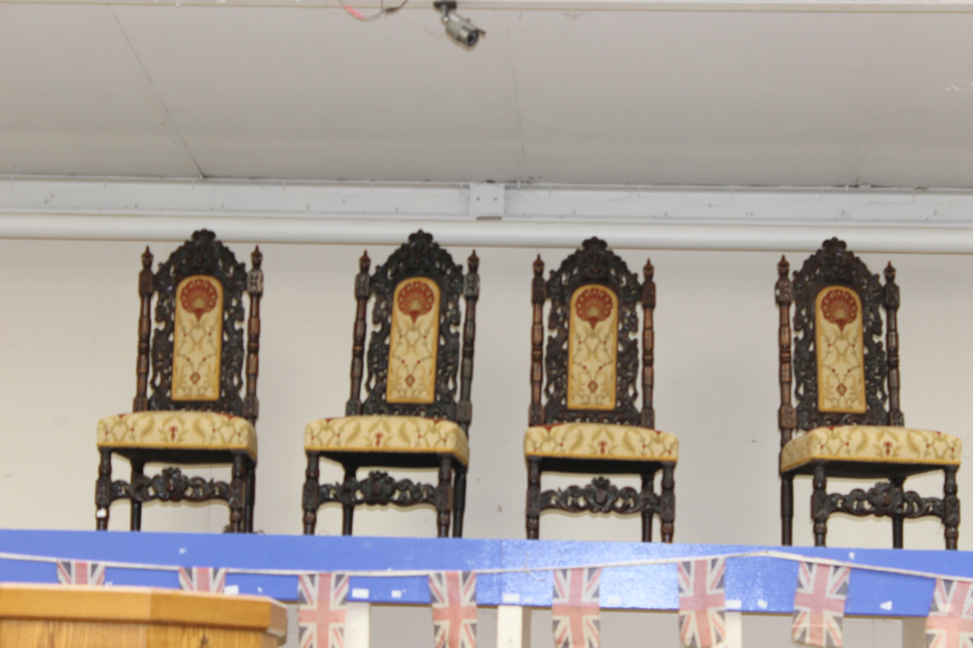A set of four Victorian Carolean style oak dining chairs, carved backs, lion masks,