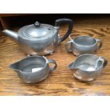 Liberty, a Tudric pewter Arts and Crafts four piece teaset, planished, on four feet,