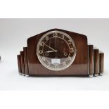 An Art Deco walnut eight day mantle clock, having Westminster, St Michaels and Whittington chimes,