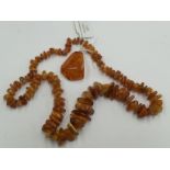 A rough cut amber necklace and a pendant