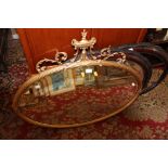 A late 19th Century oval framed wall mirror,