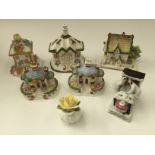 A collection of five Coalport cottage figures, comprising 'The Gate House', 'Keepers Cottage',