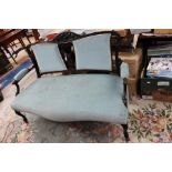 An Edwardian mahogany settee, carved crest rail, blue upholstered back and seat,