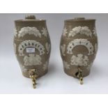 A pair of salt glaze pub barrells 'Gin', 'Brandy', both with brass taps,