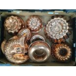 A box of assorted Victorian copper jelly molds of varying designs and sizes,