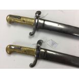 A pair of French 1866 Pattern Chassepot bayonets. Non matching numbers. Complete with scabbards.