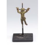 A bronze fitting in the form of Cupid, head turned to the right, body naked except for a sash across