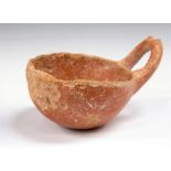 A Cypriot Western Asiatic red burnished pottery dipper. C.1900 BC. Surface loss and chips. Ex.