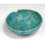 Egyptian Ptolemaic Faience Bowl, C. 332 - 32 BC.   A blue glazed faience bowl with pedestal base.
