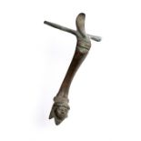 A bronze vessel handle with cuff and thumb guard to the top. Arching body with collar to top and