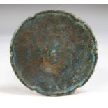 Chinese Mirror, Tang Dynasty, 618-907 AD.  A bronze oval mirror with scalloped edges to form a lotus
