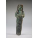 Egyptian dark green glazed faience shabti figure, c.1300 - 1100 BC. A dark green glazed faience