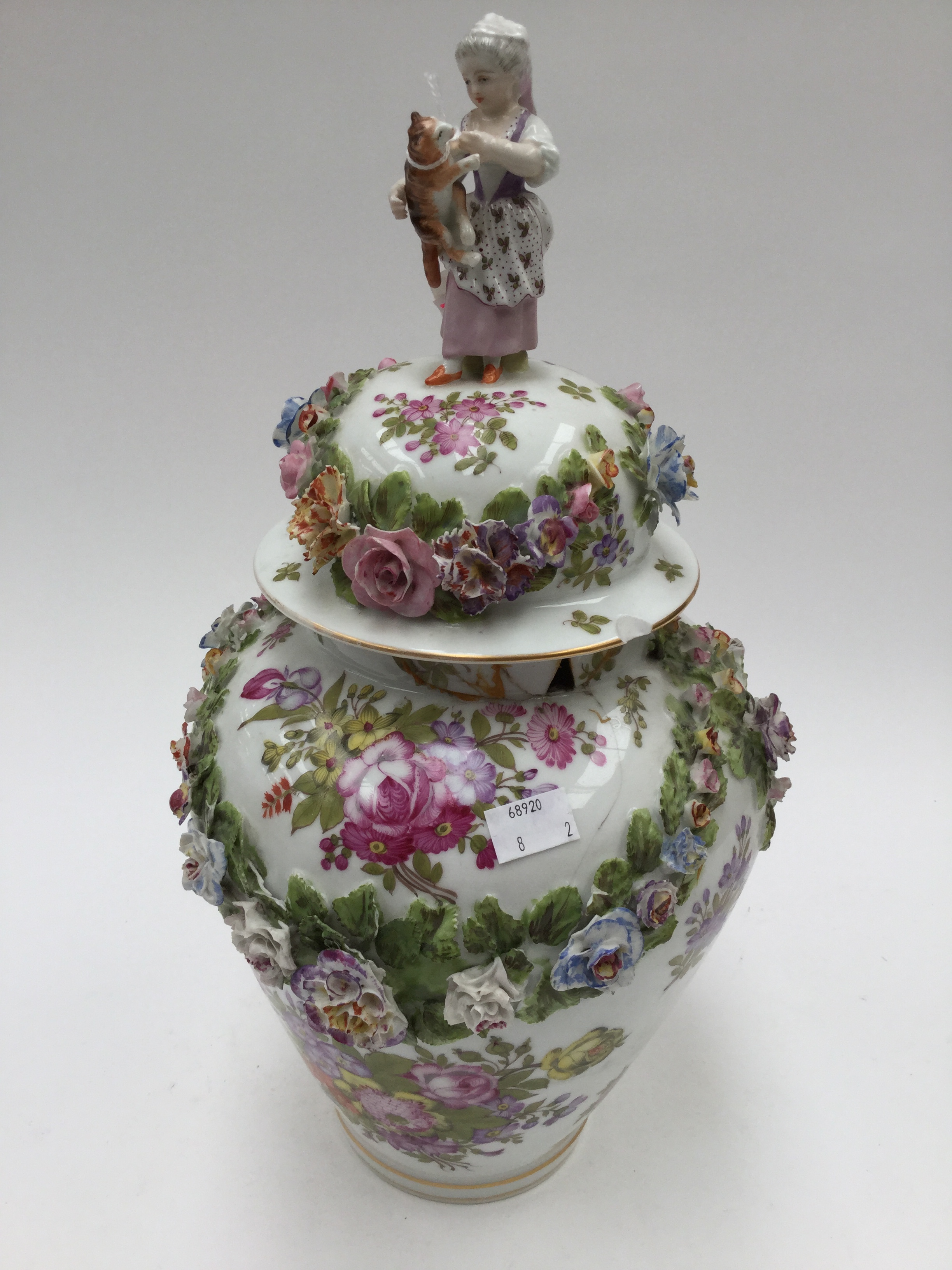 A large Meissen baluster vase and cover, painted with floral sprays and applied swags of flowers,