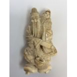 Early 20th century carved ivory Japanese figure of an older gentleman with a young child in a rope
