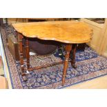 A Victorian walnut Sutherland table with fret work supports and stretcher,