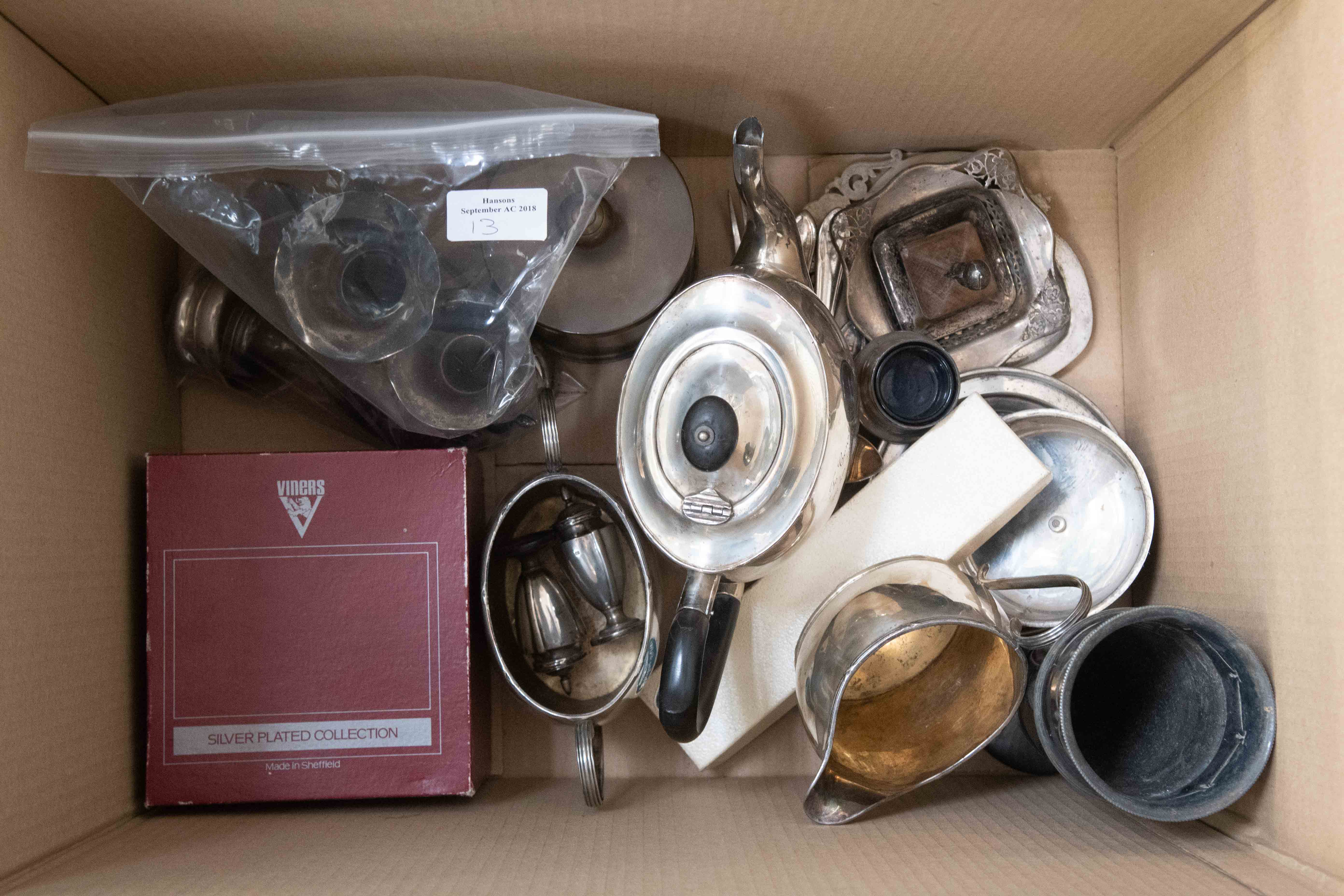 A box of assorted silver plated ware to include small silver pill box, small trophies,