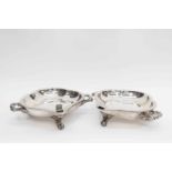 A pair of silver plated muffin dishes on three scroll feet,