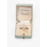 A solitaire diamond ring, claw set old cut diamond, scroll cross over shoulder diamond set,