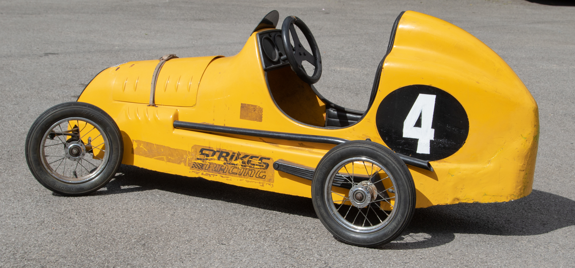 Pedal Car: A yellow, Strike's Racing, Model 750 Racer, racing pedal car, No.
