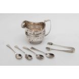 A George III silver cream jug, with gadroon border, raised on ball feet, London 1811,