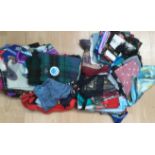 A collection of scarves to include silk, crepe, polyester, a new plaid scarf,