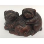 Early 20th Century Chinese terracotta figure of a dog and puppy with ruffled collar,