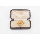 A Regency yellow metal brooch with seed pearl set in star cutting,