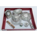 Silver embossed dressing table set, Birmingham, indistinct date mark, clock,