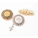 An unmarked yellow metal circular mourning brooch, possibly 14ct gold, set with seed pearl,