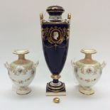 A pair of Royal Doulton twin handled vases, having floral decoration and swags,