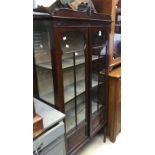 An Edwardian mahogany display cabinet, fitted with two glazed doors,