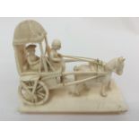 An early 20th Century Indian carved ivory group figure of horse and cart with a male and female