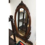 A large 20th Century beech framed hand carved over mantle mirror