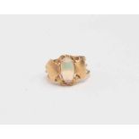 An opal ring, unmarked yellow metal with elongated solid opal, approx 11mm x 6mm,