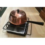 A mid century copper fondue on stand with burner