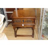 An Old Charm oak side table, fitted with a single drawer, standing on turned legs,