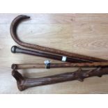 An antique sword stick, a knarled wooden cane,