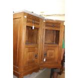 A pair of late Victorian oak marble topped bedside cabinets,