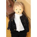 A Horsman 1920's doll, with original clothes together with a quantity of dolls clothes.