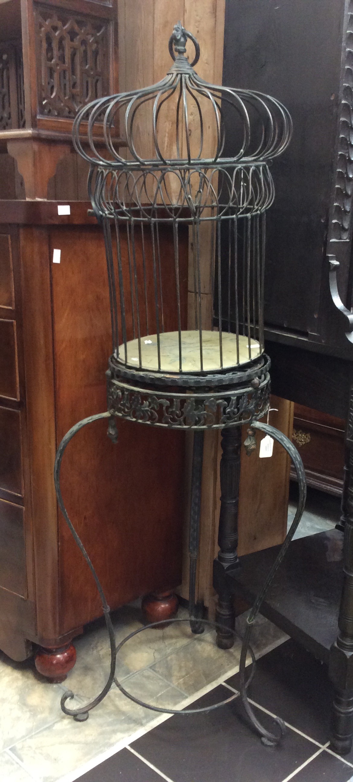 An ornamental cast metal table top bird cage
