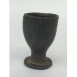 A small pewter cup 7cm in height, 4.5cm in width. Some circular decoration around the rim.