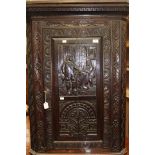 A 19th Century oak hanging corner cupboard, having a carved door,