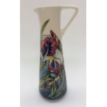 A Moorcroft jug, 'Iris' pattern, on cream ground (seconds), initialled 'WM M.C.C.