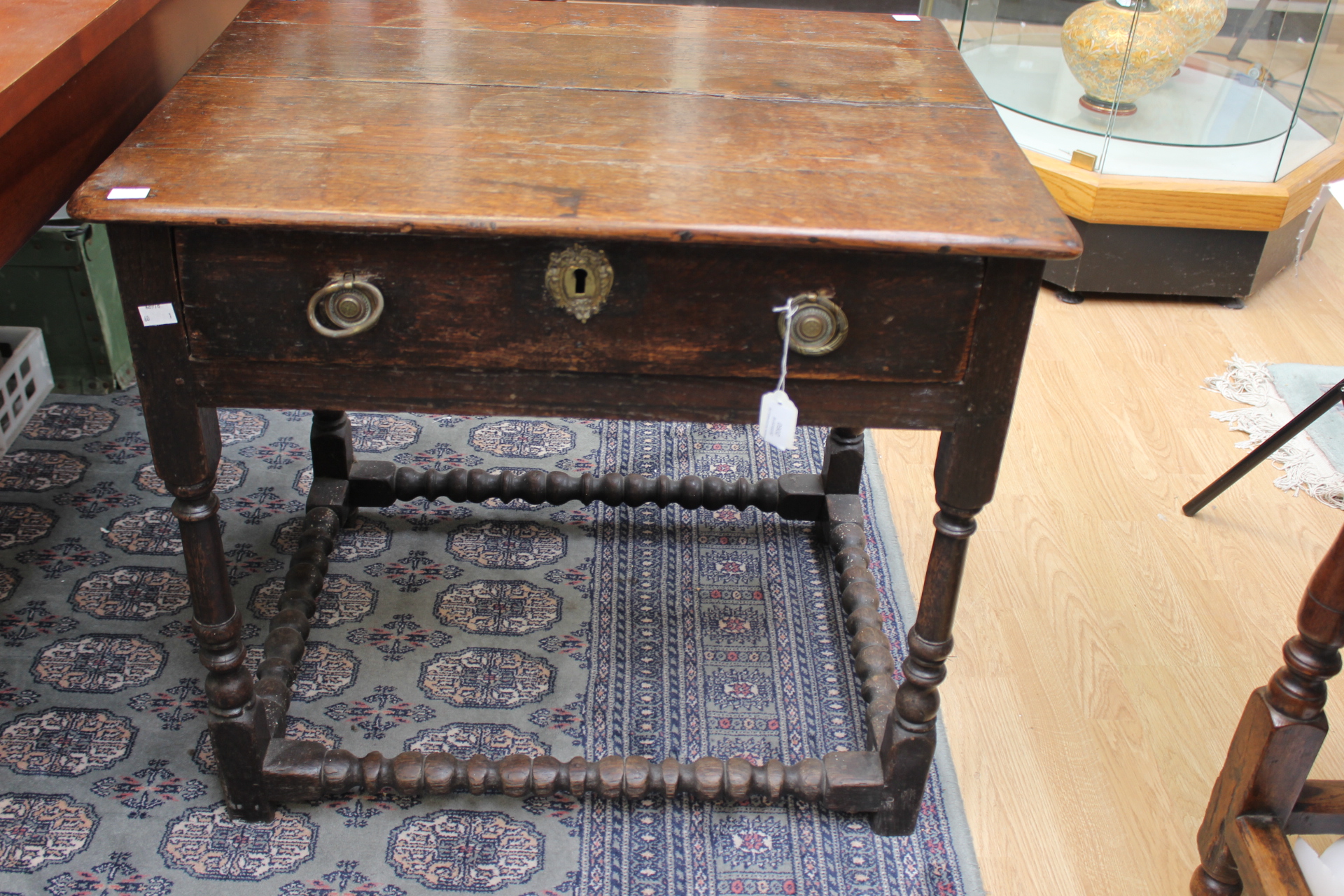 A late 17th Century oak side table, joined construction, fitted with a single drawer,