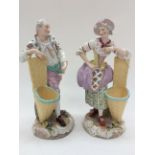 A pair of late 19th Century tinted hard paste figural match holders (sd) (2)