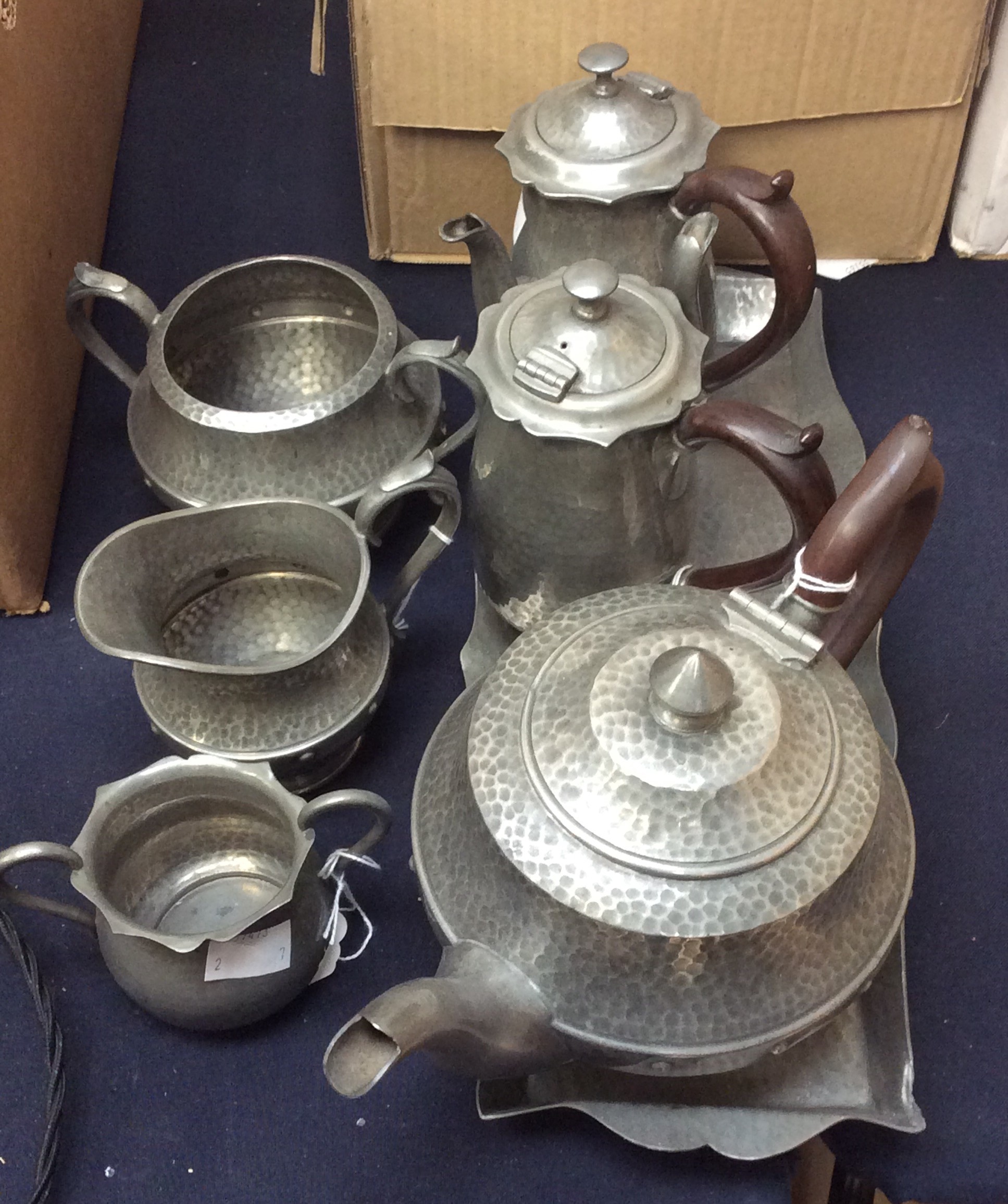 Planished pewter, a pair of chocolate pots and a matching sugar bowl and tray,