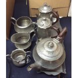 Planished pewter, a pair of chocolate pots and a matching sugar bowl and tray,