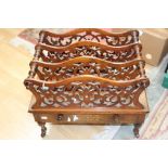 A Victorian walnut three tier Canterbury,