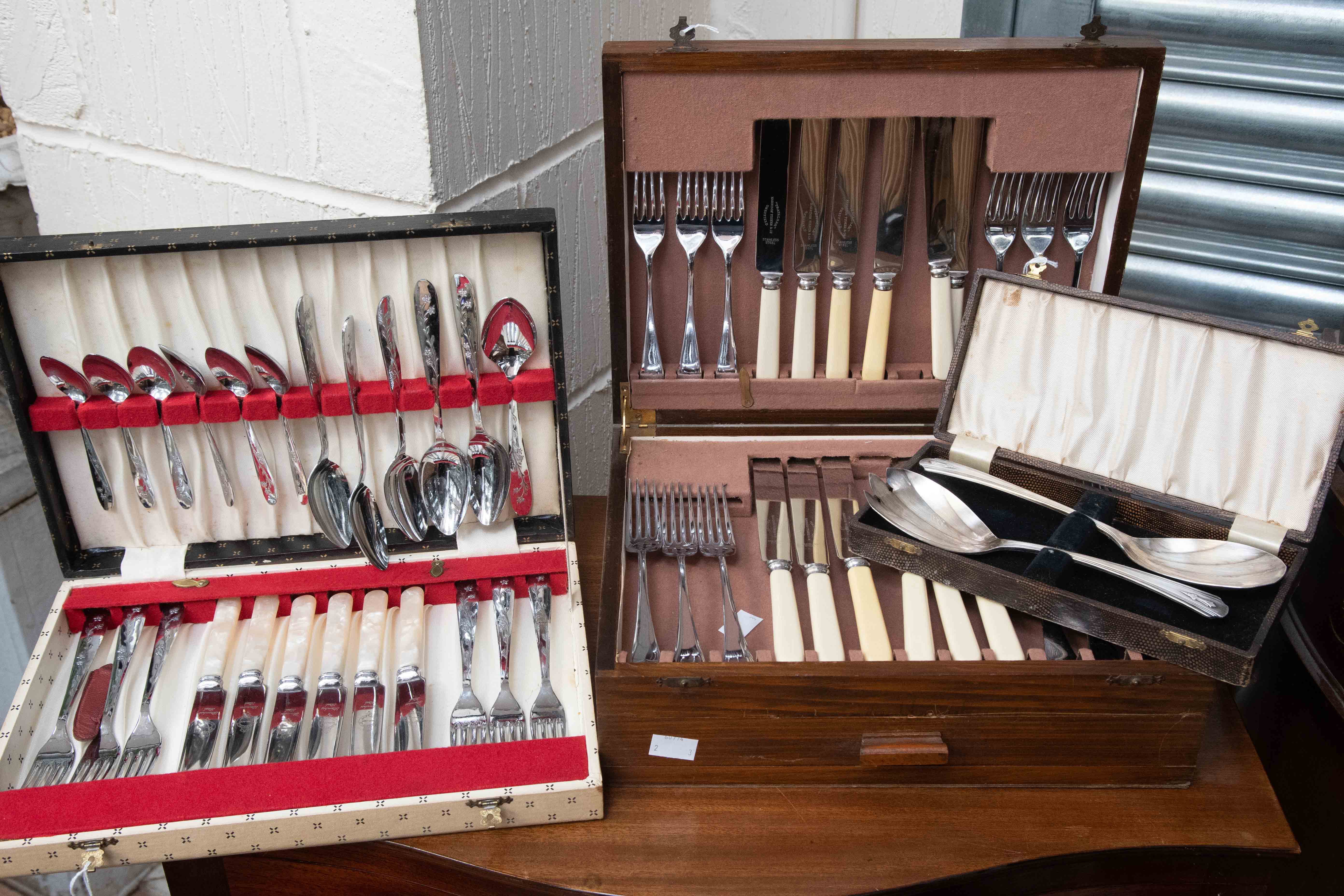 A canteen of cutlery and a box set of George V salad servers and wooden case (1950) of cutlery (3)